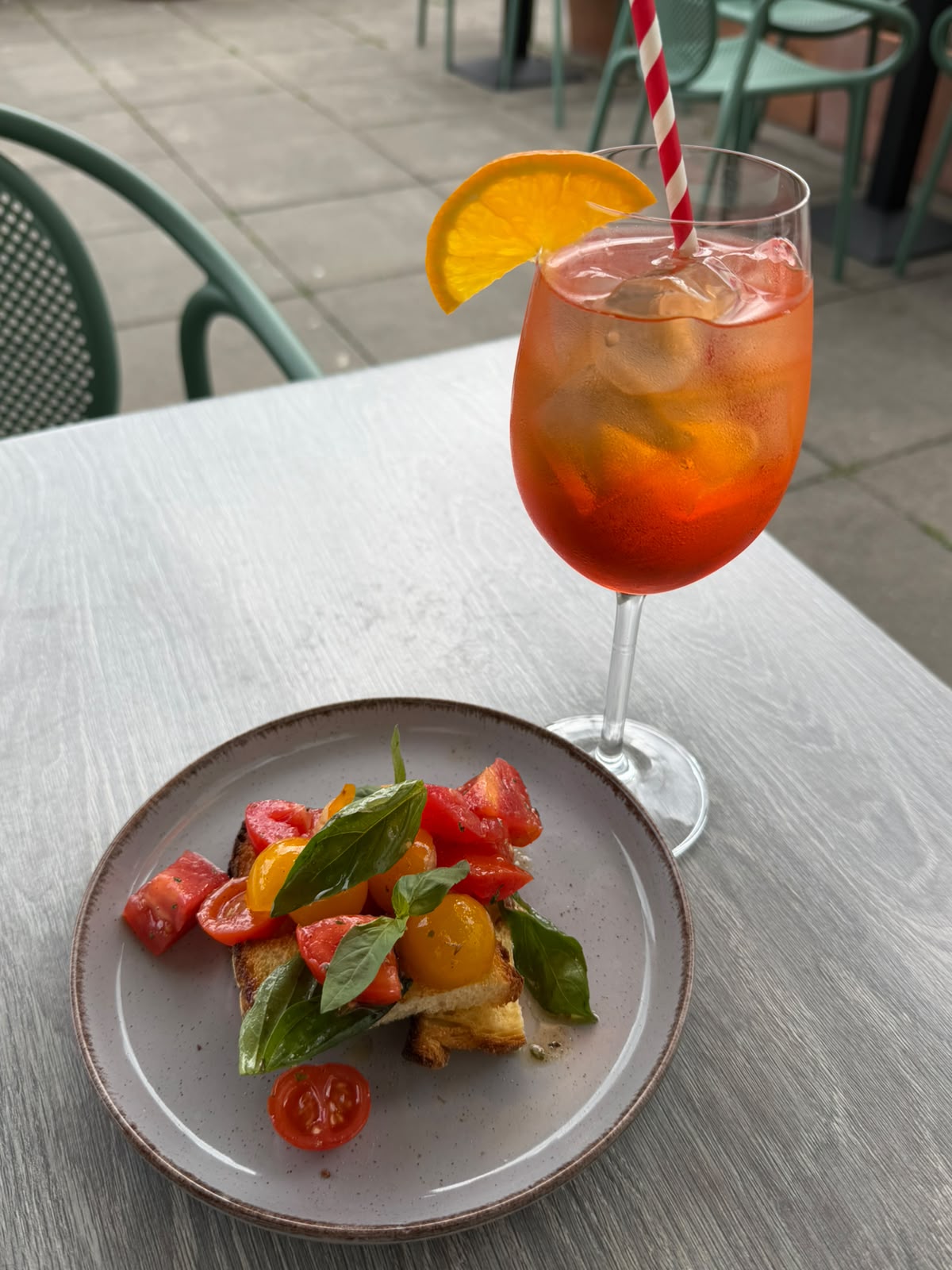 Aperol spritz beside bruschetta